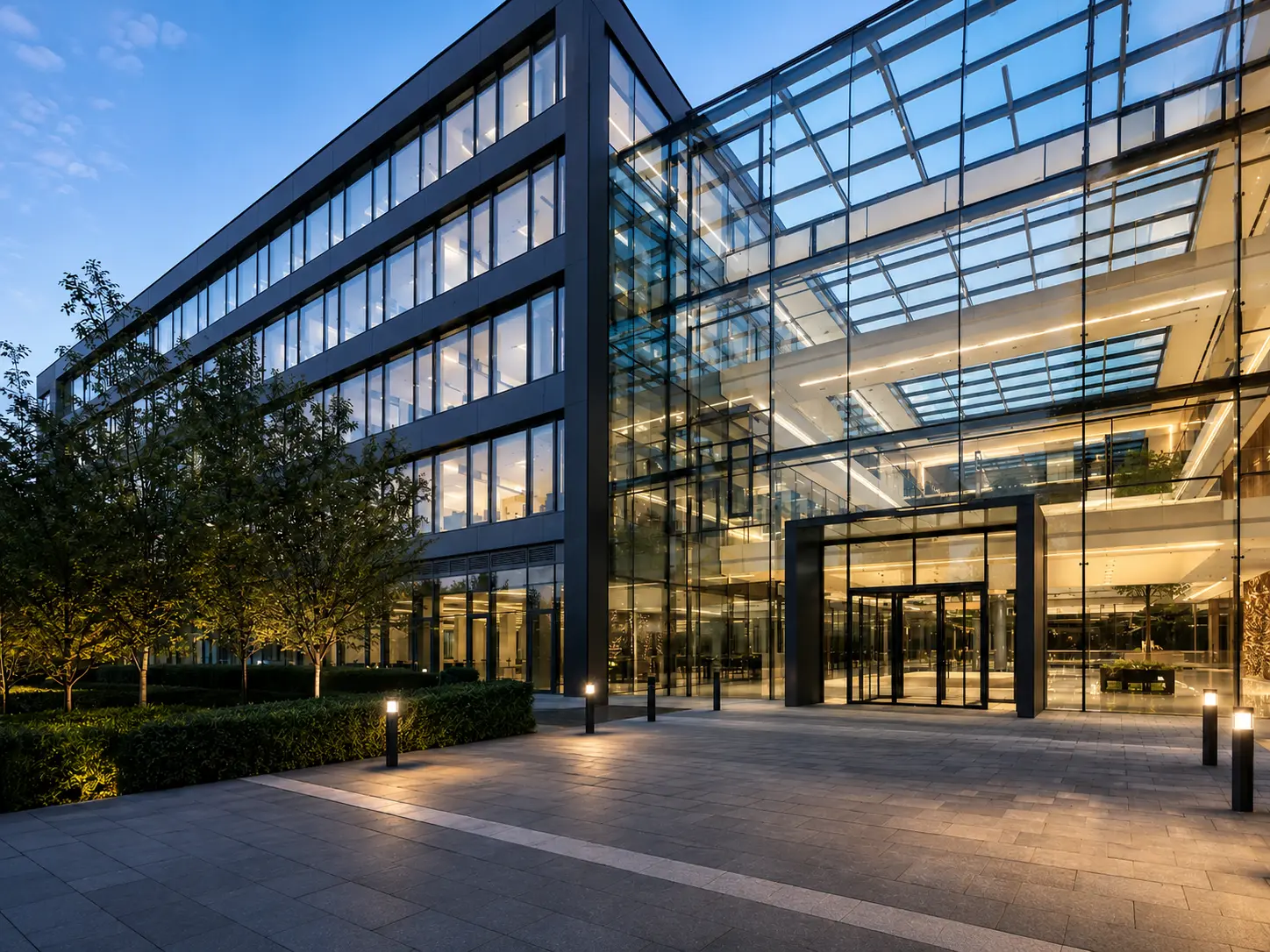 Modern glass commercial building at dusk