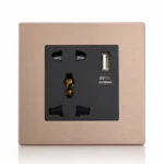 Brushed rose gold metal universal wall socket with integrated USB-A charging port